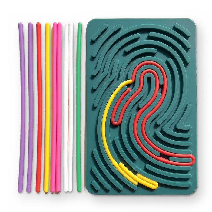The dark green board, with red and yellow strings pressed into its grooves and a row of loose strings beside it