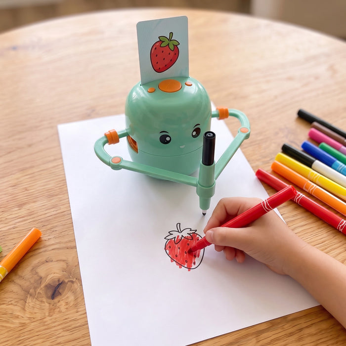 The robot has drawn a strawberry from its card, and a child's hand fills it in with a red marker