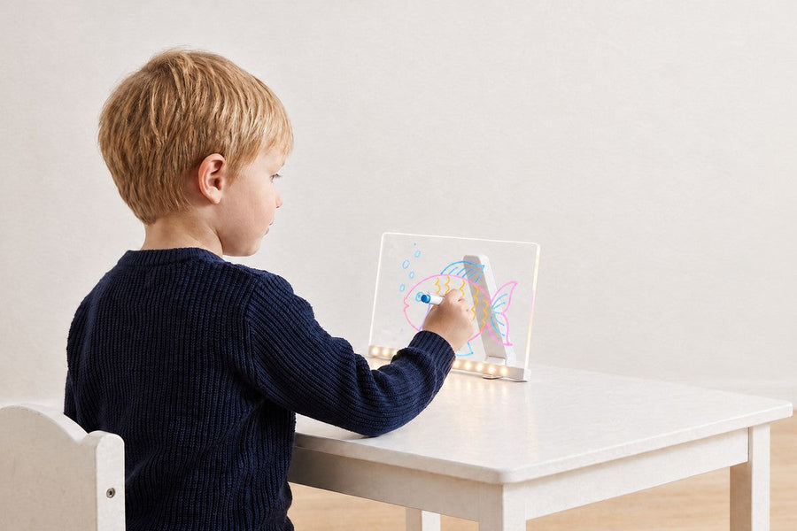 A child playing with the LuminoSketch Pad