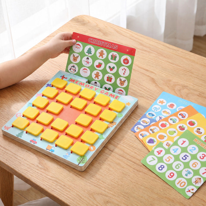 A child slides a Christmas picture card into the top of the board, with more cards on the table, such as ocean animals, fruit and numbers 1 to 10