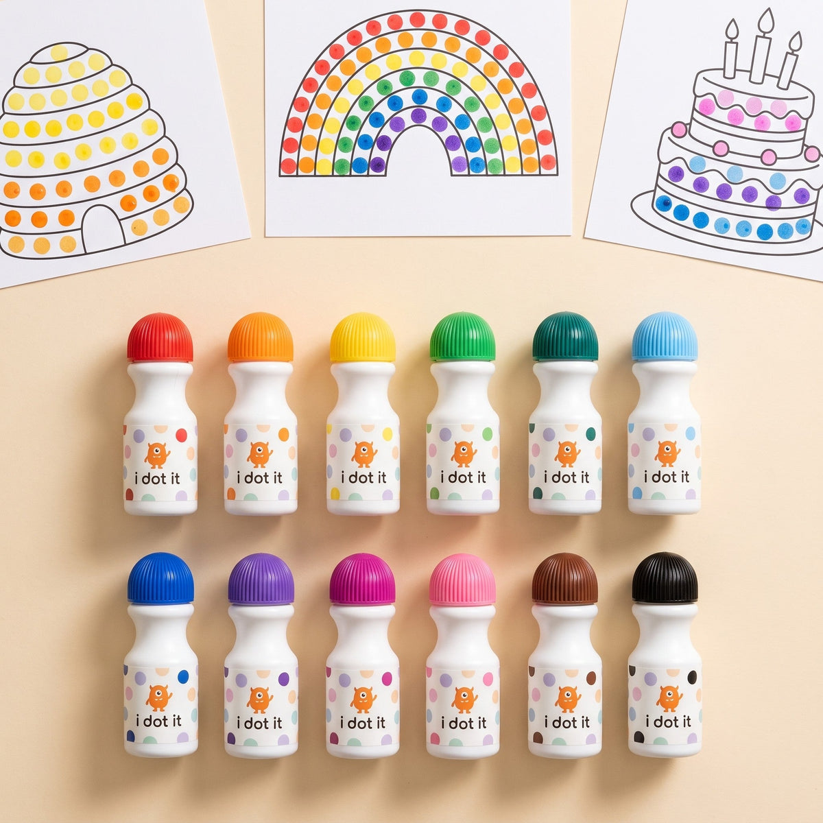 Twelve dot markers in two rows of colors, below three dotted activity sheets: a beehive, a rainbow and a cake with candles